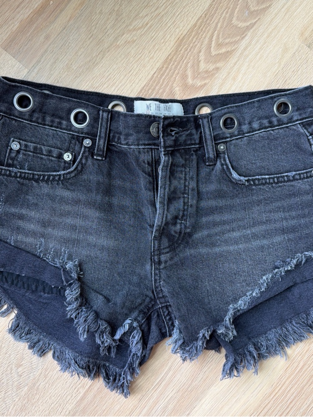 We The Free Washed Black Eyelet Waist Frayed Denim Shorts
